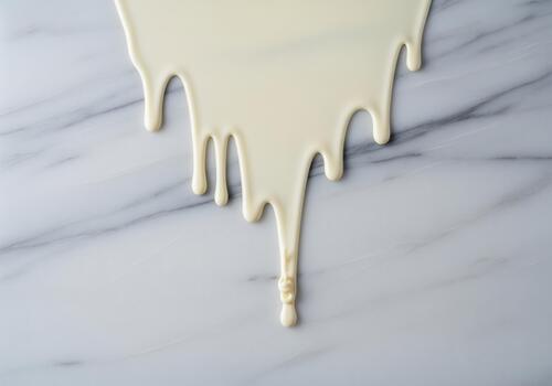 Smooth flow of sweet white chocolate drip cascading over a luxurious marble texture. photo