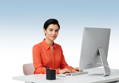 Focused professional woman working diligently at her desk using a modern computer. photo