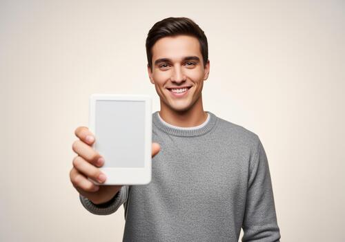 Attractive young man smiling and presenting a blank white e reader screen display photo