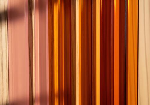 Vibrant abstract texture featuring vertical glossy strips in warm amber and orange colors photo