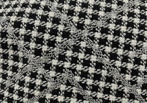 Elegant black and white houndstooth tweed fabric texture with shiny silver diagonal pattern photo