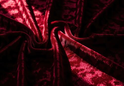 Luxurious deep crimson crushed velvet fabric texture with dramatic folds and rich shadows. photo