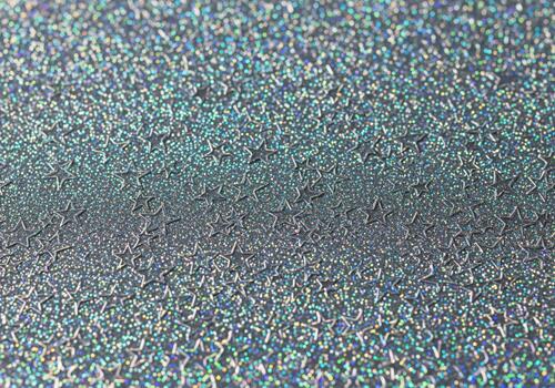 Holographic silver glitter background texture with continuous embossed star pattern. photo