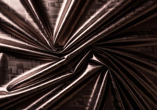 Dynamic dark bronze metallic fabric background with sweeping folds and shiny texture photo