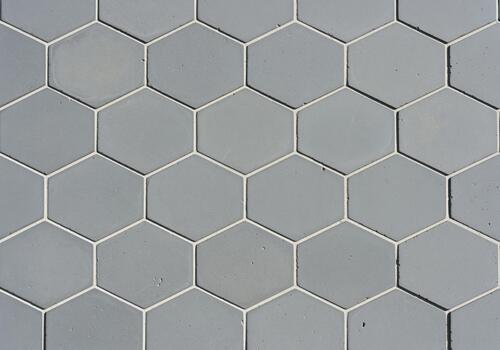 Geometric seamless pattern of gray hexagonal tiles with white grout lines photo