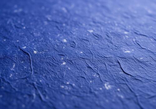 Captivating macro photograph of richly textured deep indigo blue handmade paper background photo