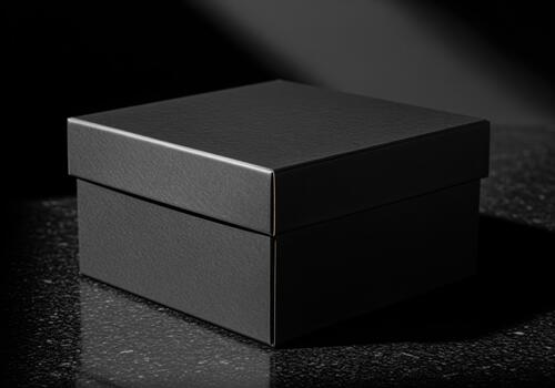 Elegant black square gift box with lid on a dark textured surface, dramatic studio lighting. photo