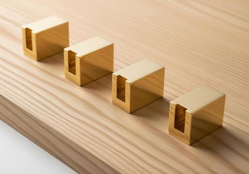 Gold metal brackets in a row on wood surface for furniture design photo