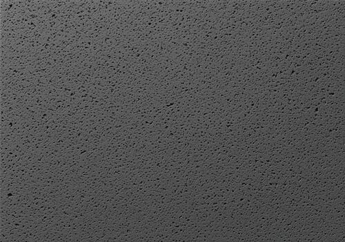 Honed basalt stone countertop featuring a uniform dark gray porous texture photo