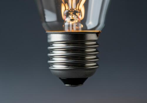 Extreme close up of incandescent light bulb with glowing filament photo
