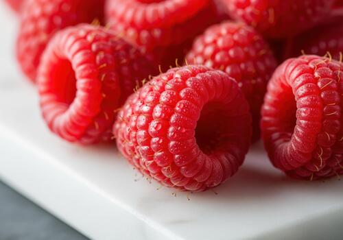 Close up of fresh, ripe raspberries displaying vibrant red color photo