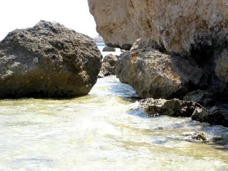 Rocky Desert Shore of the Red Sea With Clear Waters and Tidal Movement Under Bright Sunlight photo
