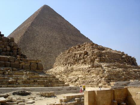 Exploring the Pyramids of Giza Against a Clear Blue Sky in the Egyptian Desert photo