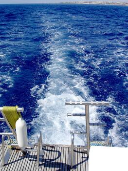 Yachting trail with breakers from the back of a boat or yacht photo