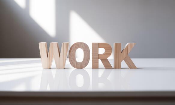 Wooden letters spelling work on a table photo