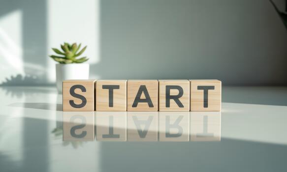 Start block on white table with potted plant photo