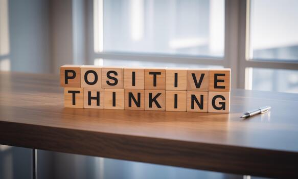 Positive thinking block on wooden desk photo