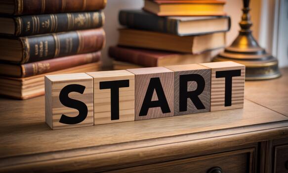 Start block word on wooden table with books and lamp photo