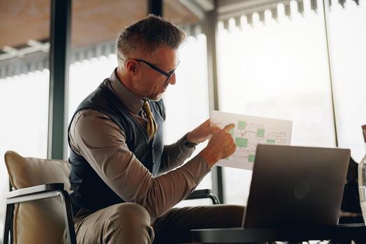 A Business Professional Engaged in the Task of Analyzing Data Within a Modern Office Setting photo