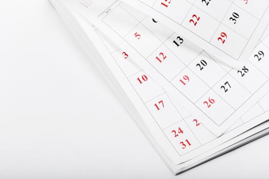 Calendar pages showing dates of a month with clear markings on important days photo