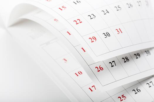 Calendar pages turning in a close-up view showcasing different dates in a month photo