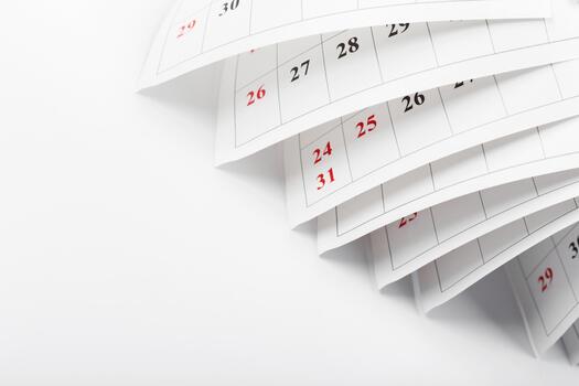 Pages of a calendar flipping to show days in a month with emphasis on dates and organization photo