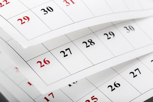 Calendar pages showing dates of a week in a close-up view during a workday photo