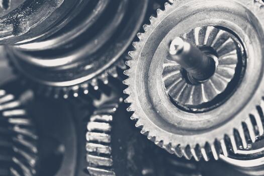 Close view of metal gears and cogs in a mechanical assembly at a factory photo