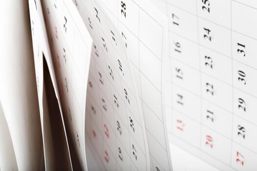 Calendar pages turning in a close-up view during the passing of time photo