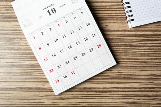 Calendar page of October 2017 showing dates and week layout on a wooden table photo