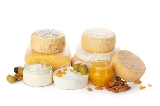 Assorted cheese selection with spreads and nuts arranged artistically on a white background photo