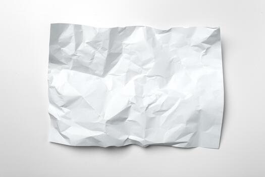 Crumpled white paper resting on a flat surface in a simple setting photo