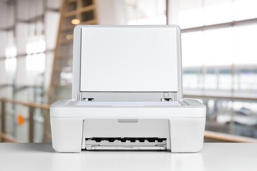 Modern printer on display in a bright office environment with large windows in the background photo