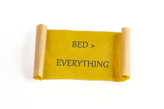 A cheerful message is displayed on a rolled parchment, proclaiming that a bed is greater than everything else. This simple yet impactful statement reflects a love for rest photo