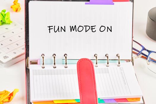 Colorful notes and a planner titled Fun Mode On create a lively atmosphere for planning and organizing tasks, encouraging creativity and focus in this bright workspace setting photo