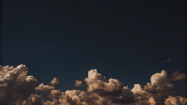 Dramatic fluffy clouds drifting across a deep blue sky at dusk for use as a background or texture in your creative projects photo