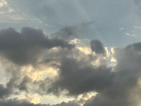Sunbeams Pierce Through Dark Clouds in the Sky light rays photo
