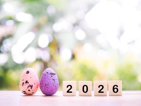 Easter eggs and wooden block with number 2026. Concept for EASTER DAY in new year 2026 photo