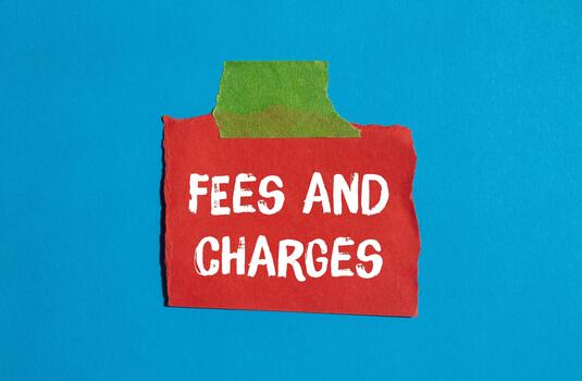 Fees and charges message written on ripped torn paper background. Conceptual Fees and charges symbol. Copy space. photo