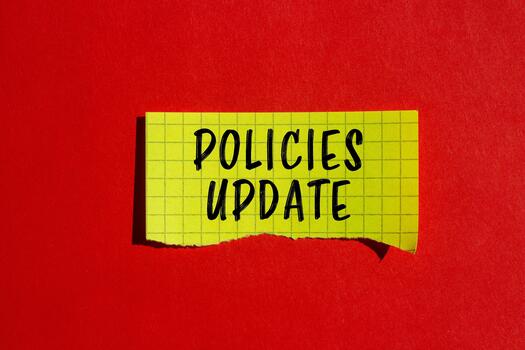 Policies update message written on ripped torn paper background. Conceptual Policies update symbol. Copy space. photo
