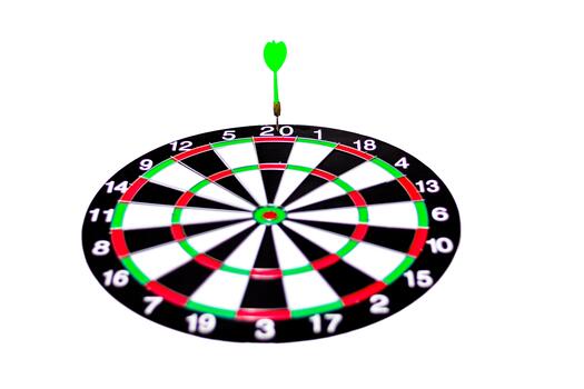 A dartboard with a green dart sticking into the bullseye, a game of skill and accuracy photo