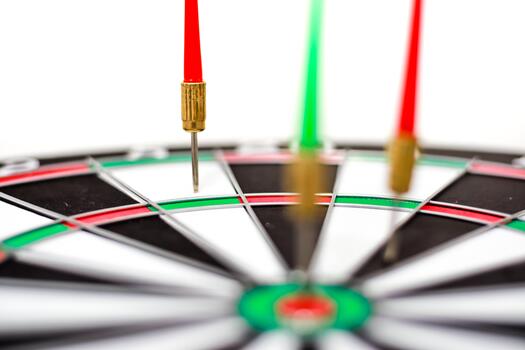 Close-up of a dartboard with darts in the bullseye showcasing precision targeting photo