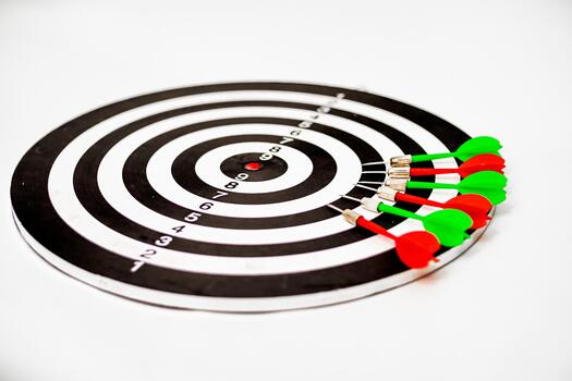 Dartboard with multiple darts hitting the target, symbolizing accuracy and precision photo
