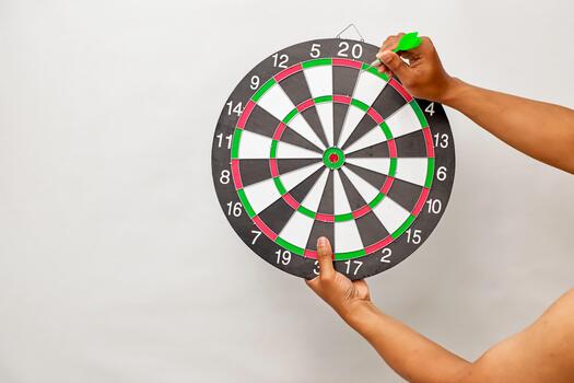 A person throwing a dart at a dartboard aiming for the number twenty, a game of skill and precision photo