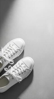 Product mockup for white canvas sneakers, perfect for advertising, branding display, and commercial presentation with a minimal design and clean background photo