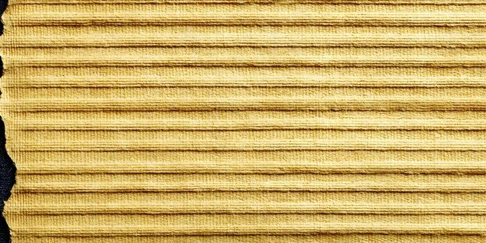 A close up view of golden yellow corduroy fabric with horizontal ridges creating a textured background photo