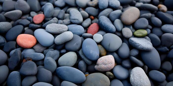 A close up view of colorful smooth beach stones and pebbles creating a natural background texture photo
