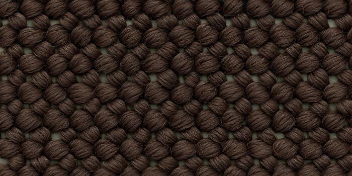 This image shows a detailed close up of a rich dark brown woven textile with a distinctive textured loop pattern photo