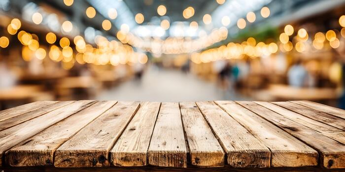 Empty rustic wooden table with a blurred background of warm golden festive string lights perfect for product displays photo
