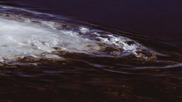 Waves crashing on dark water at twilight photo